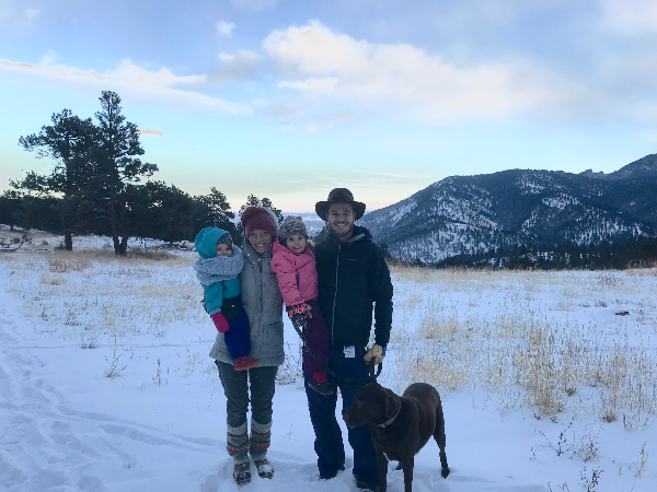 Tara and her family in front of the mountains on a snowy winter day