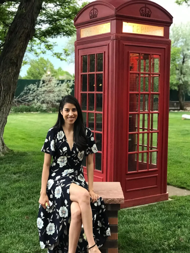 Elizabeth sitting in front of a red phone booth