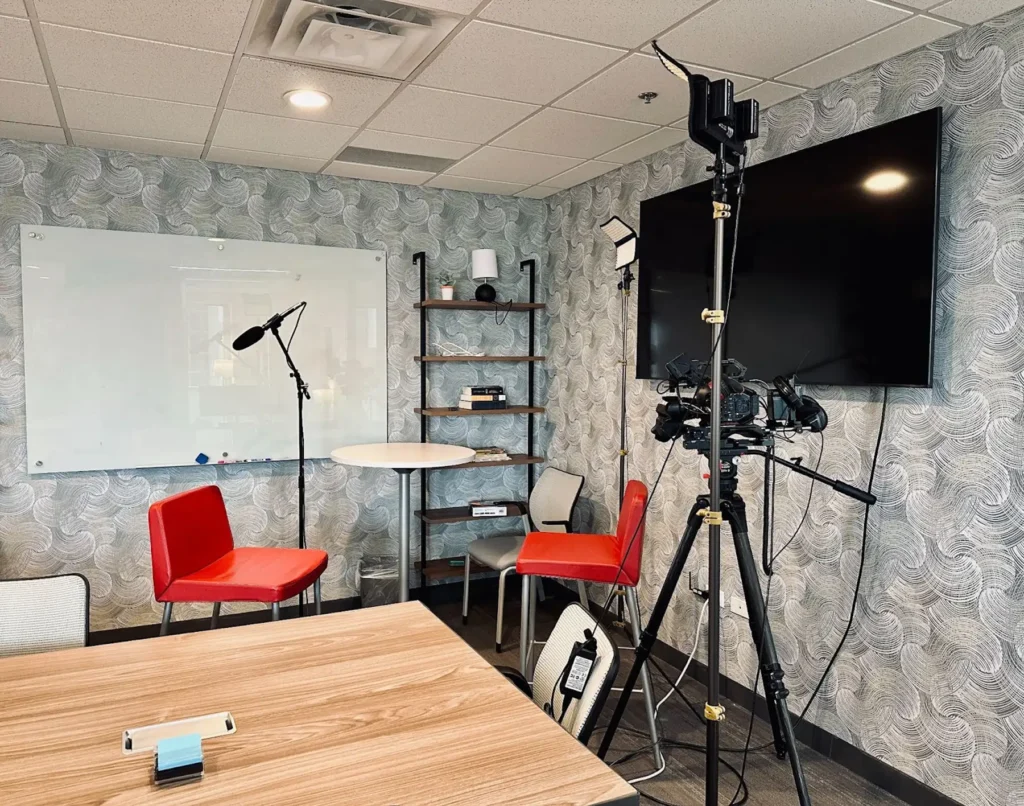 Camera equipment set up in a room with two chairs facing each other