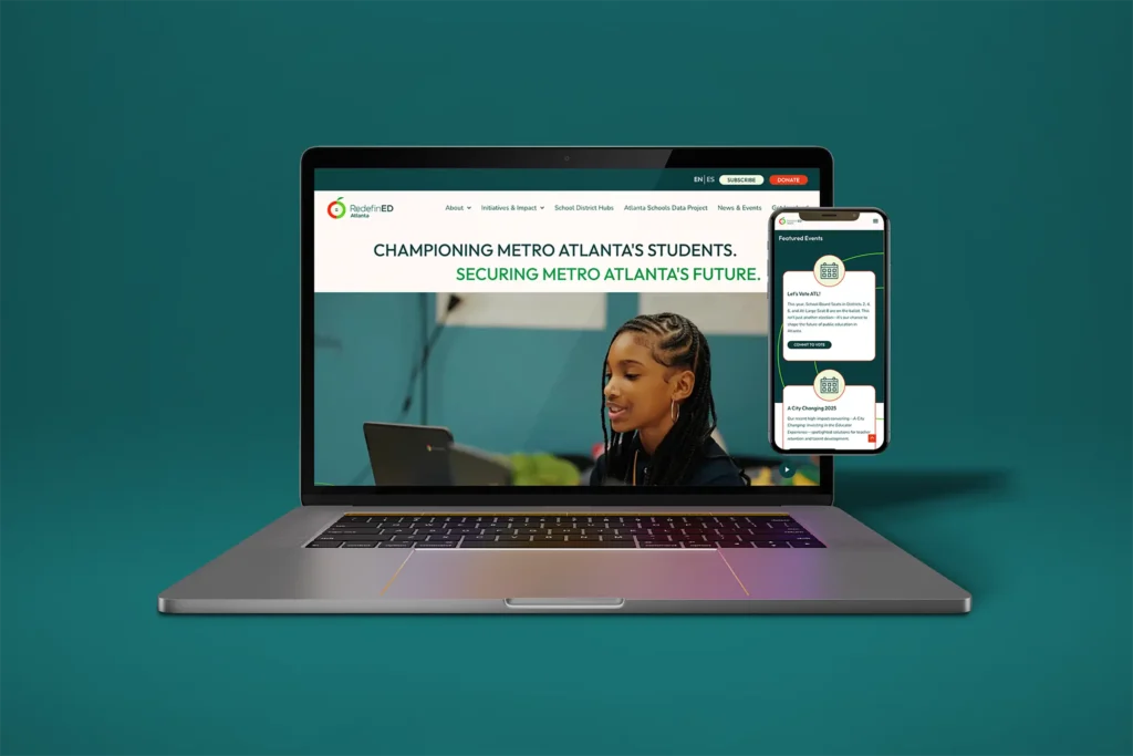 Laptop computer with homepage of RedefinED displayed, mobile phone showing a different part of the page in responsive format