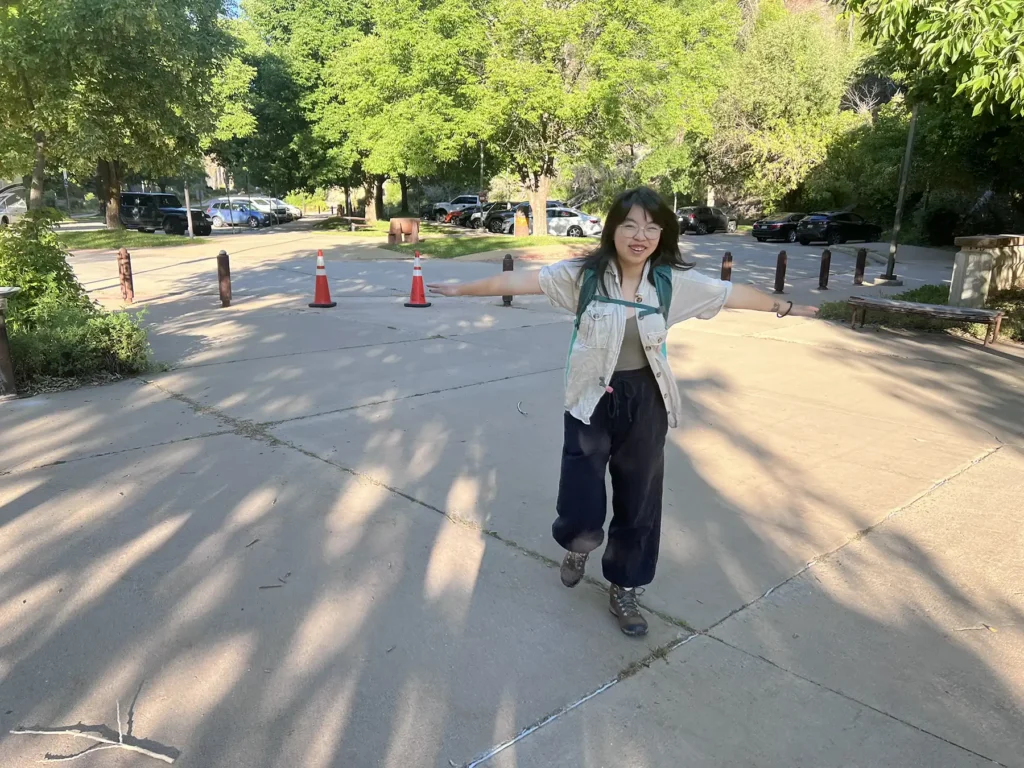 Barefoot's 2026 Intern, Kaia, walking happily on a sidewalk with her arms out to the side