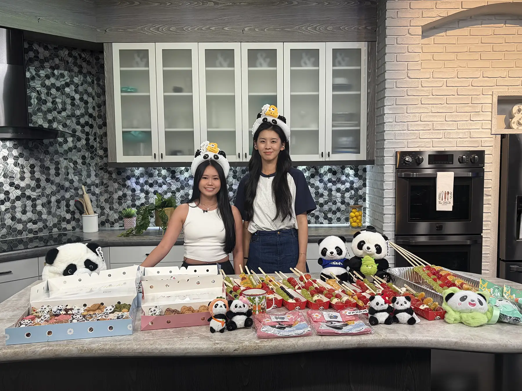Two women from Panda Fest wearing panda headbands