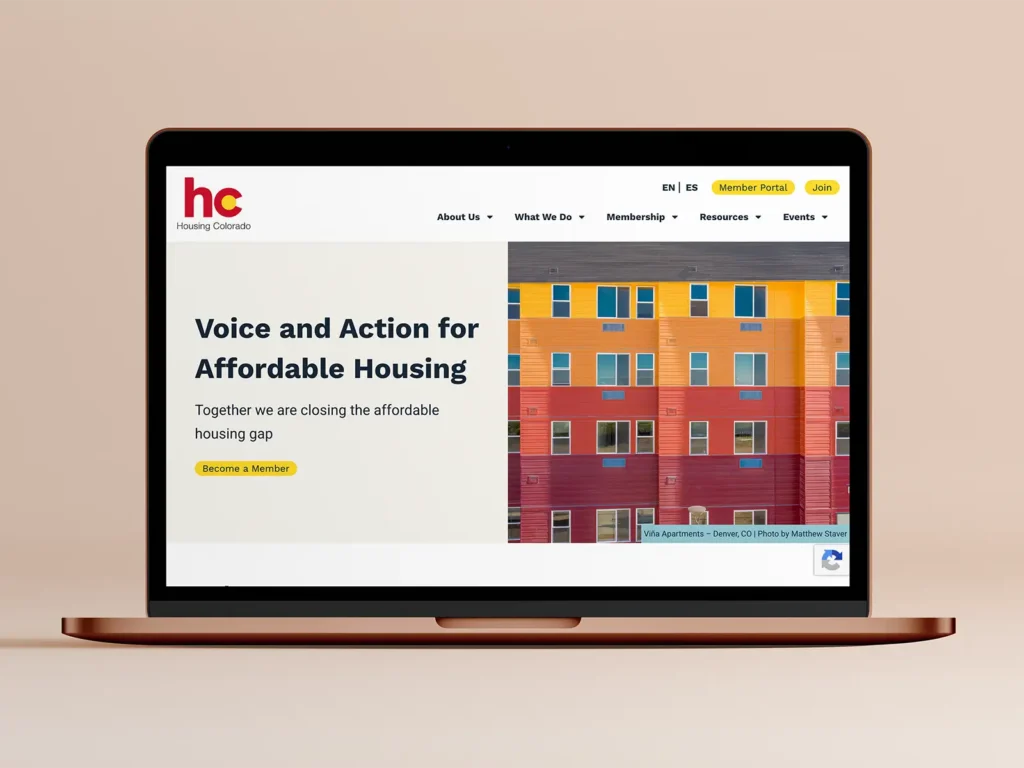 A mockup of the Housing Colorado website on a macbook
